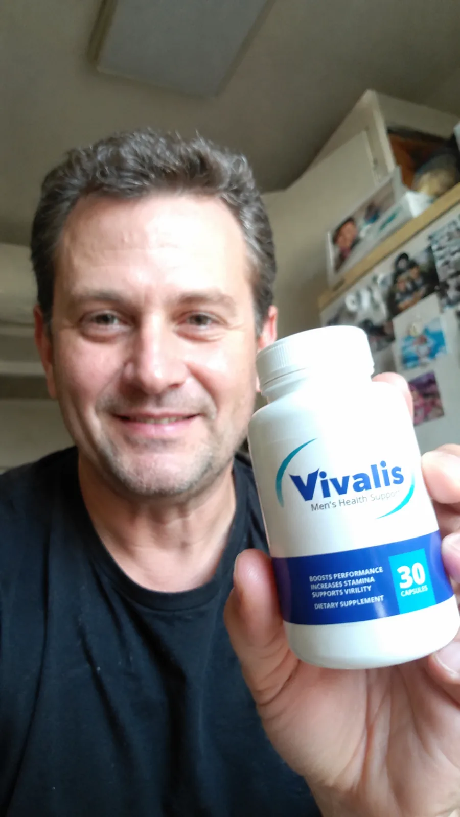 Holding a bottle of Vivalis at home